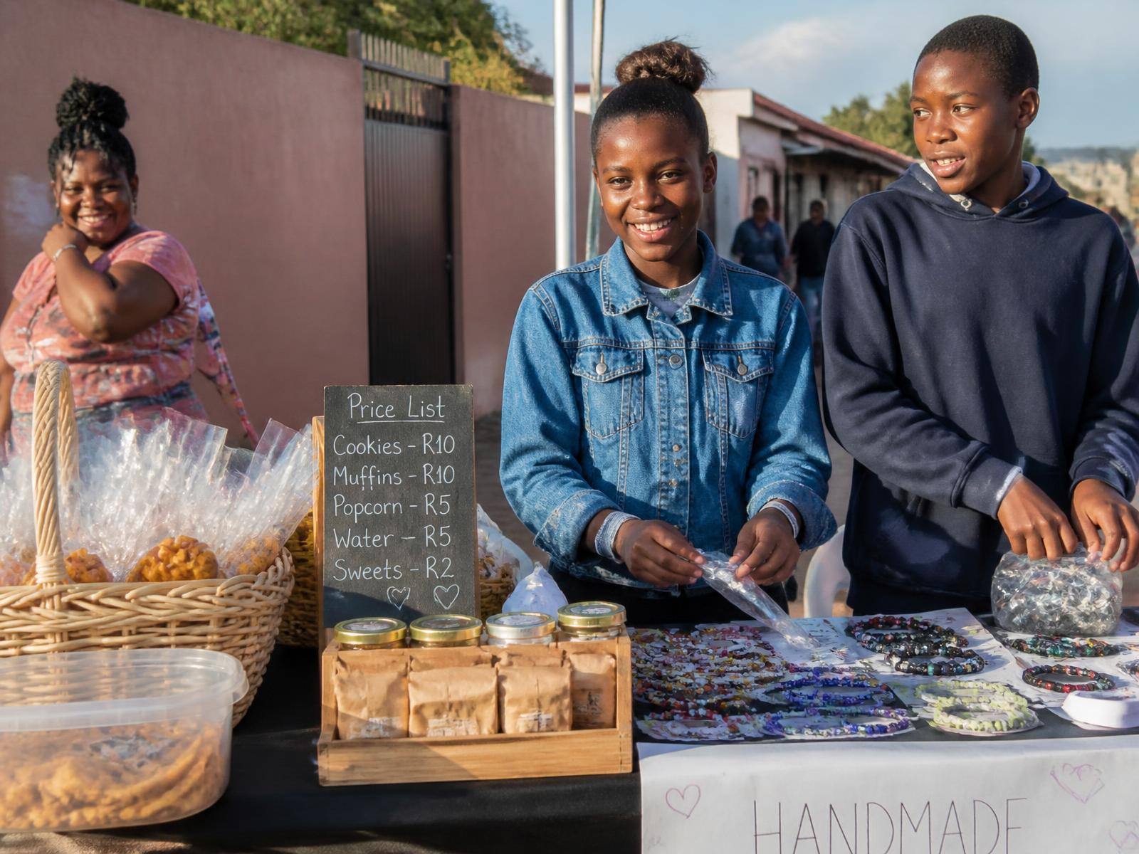 Two South African teenagers running their own market stall in their community